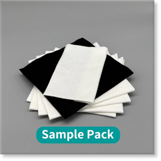 Tunika Disposable Salon Towels Image showing a fanned out mixed stack of Black and White sample towels in various sizes for a Sample Pack