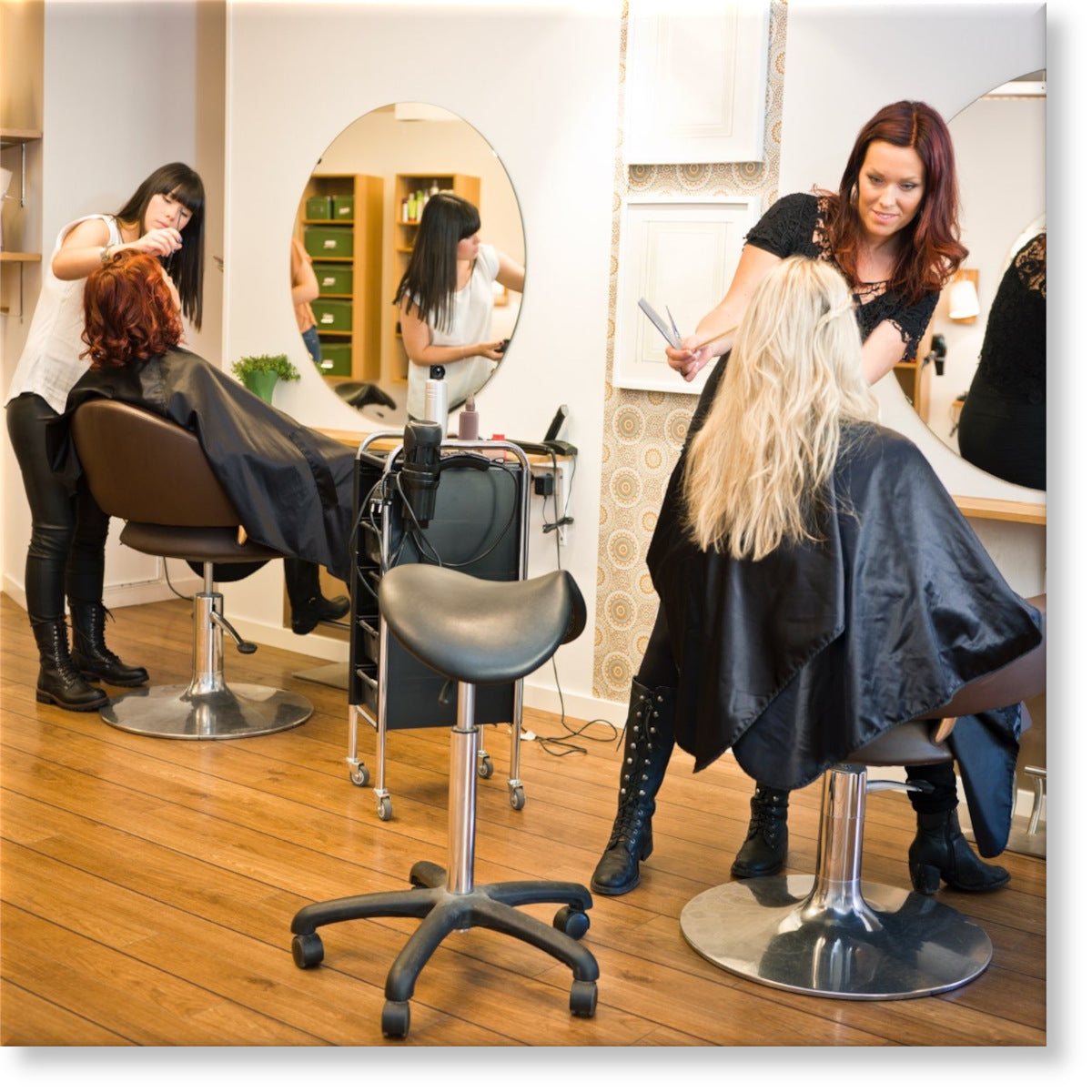 Image of a two Hair Stylists in a Salon providing hair and beauty treatment